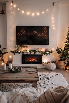 a living room decorated for christmas with lights and garlands on the fireplace mantel