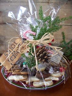 a basket filled with cookies and candy canes on top of a wooden table next to a christmas tree