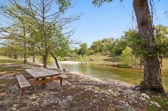 a picnic table sitting next to a river