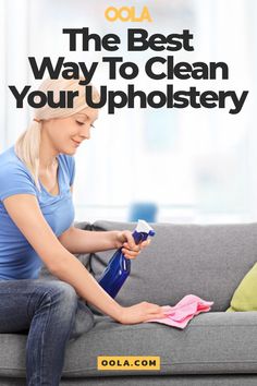 a woman sitting on a couch holding a spray bottle and cleaning her hands with a rag