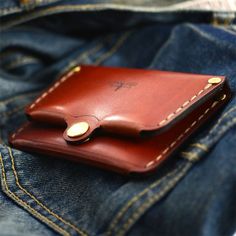 a leather wallet sitting in the pocket of someone's jean pants with his jeans on