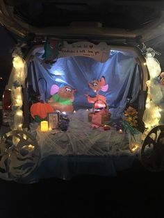 the inside of a car decorated with christmas lights and animated characters, including ratty