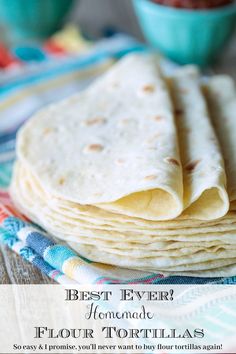 a stack of tortillas sitting on top of a wooden table