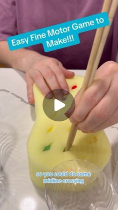 a person holding chopsticks over a piece of cheese with the words easy fine motor game to make