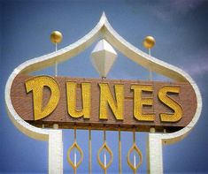 a sign that says dunnes on it in front of a blue and white sky