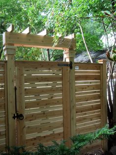 a wooden fence in the middle of a yard