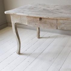 an old wooden table with two drawers on one side and a drawer on the other