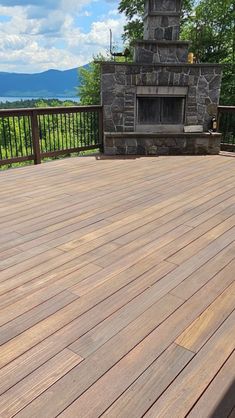 a wooden deck with a fire place in the middle