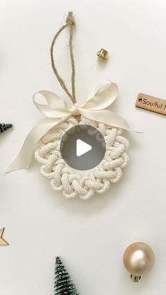 an ornament hanging from the side of a white wall next to christmas decorations