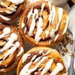 several cinnamon rolls with icing on top of them