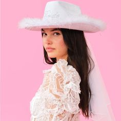 a woman wearing a white hat and veil