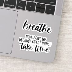 a sticker that says breathe never give up because great things take time on it