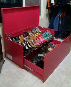 a red shoe cabinet filled with lots of shoes