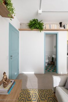 a living room filled with furniture and a plant on top of the bookshelf