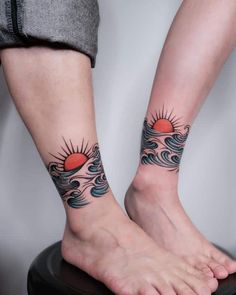 two people with matching tattoos on their feet, one has a sun and the other has waves