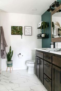 a bathroom with white tile and wooden cabinets