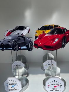 three models of cars on display in front of a white background