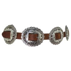 Elevate Your Style with the 1990s Brown Leather Belt! Step into the world of statement fashion with this exquisite 1990s Brown Leather Belt featuring silver-tone flower engraved buckles throughout. Crafted with meticulous attention to detail, this belt is not only a bold statement piece but also remarkably versatile. Embrace the beauty of the silver-tone flower engraved buckles that adorn this belt, creating a captivating garden-inspired design. Each buckle is a work of art, making this belt a t Vintage Metal Belt, Luxury Vintage Brown Belt, Luxury Brown Belt With Silver Buckle, Vintage Brown Belt With Brass Buckle, Vintage Brown Belt With Rivets, Gucci Boots, Statement Fashion, Belt Brown, Brown Leather Belt