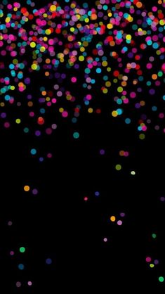 multicolored confetti on black background with space for text