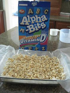 a box of cereal sitting on top of a counter next to a bag of granola