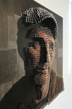 a man's head is made out of hundreds of bottle caps on the wall