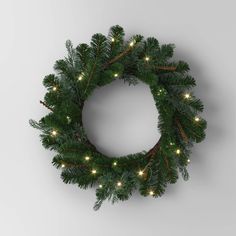 a christmas wreath with lights hanging from it