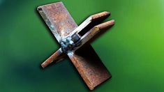 an old rusted metal object on a green background