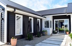 a black house with white trim and windows