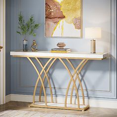 a living room with blue walls and a gold console table in the middle, along with a painting on the wall