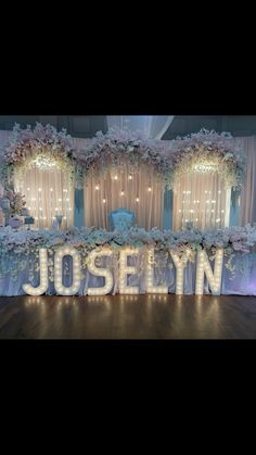 the reception table is decorated with flowers and lights