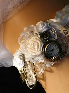 an image of a wedding garter with pocketwatch on the back of bridesmaid