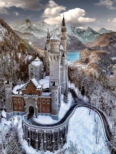 an aerial view of a castle in the middle of winter with snow on the ground