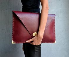 Bordeaux Symmetria Clutch.The perfect bag for all occasions!Ideal for cocktail and parties or for business meetings depending the size you choose.You can use it as a chic briefcase for your work or as a modern large clutch for a night out.This adorable clutch is handmade out of a genuine, lux Italian bordeaux cow leather.-Small size fits all your essentials, wallet, keys, mobile, cosmetics etc. -Large size fits a 15" laptop, ipad, portofolio etc and it's perfect as a file folder or as modern a l Chic Envelope Clutch For Office, Chic Envelope Clutch For Business, Modern Envelope Clutch For Office, Chic Business Envelope Clutch, Leather Envelope Clutch For Office, Elegant Envelope Bag With Laptop Sleeve, Large Clutch, Leather Clutch Bag, Small Clutch