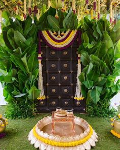 an outdoor ceremony setup with flowers and greenery on the ground, decorated in gold