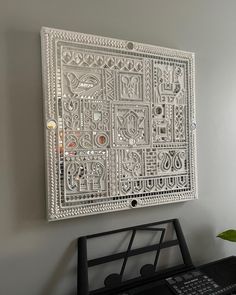 a white wall hanging over a keyboard on top of a desk