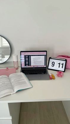 a laptop computer sitting on top of a white desk