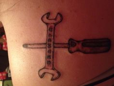 a tattoo with a wrench and the word grandpa written on it's back