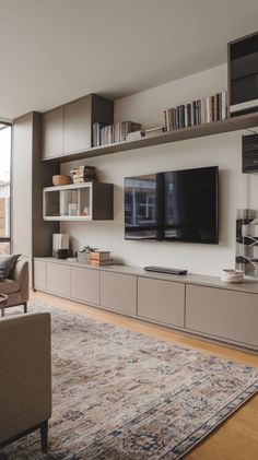 a living room filled with furniture and a large flat screen tv mounted on the wall