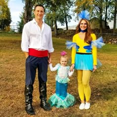 a man, woman and child dressed up in costumes