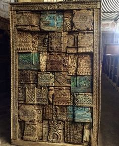 an intricately carved wooden panel with many designs on it's sides in a building