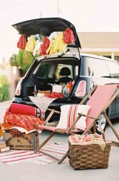 a car trunk with an open trunk and two lawn chairs in front of it