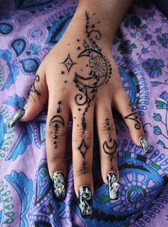 a woman's hand with black and white designs on it