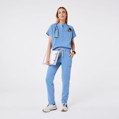 Official FIGS® Scrubs. Ridiculously Soft Scrubs Designed Just For You. Get Free Shipping On Orders $50+! | FIGS Womens Ceil Blue Montex - Mock Neck Scrub Top Poses In Scrubs, Esthetician Scrubs Outfit, Figs Scrubs Aesthetic, Ceil Blue Scrubs, Medical Scrubs Fashion, Scrub Uniform, Nursing Graduation Pictures, Fit Board, Black Fig