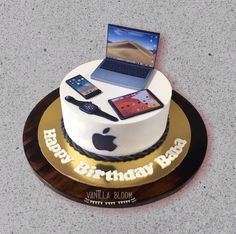 a birthday cake with an apple laptop and cell phones on it for someone's birthday