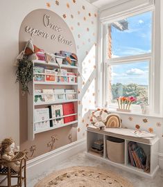 a child's room with a book shelf and toys on the floor next to a window