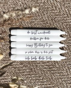 three pencils with writing on them sitting next to each other