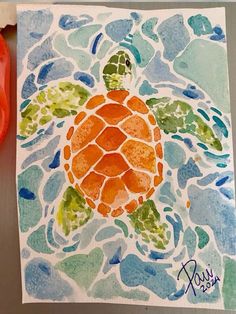 a watercolor painting of a sea turtle with blue, green and orange colors on it's shell