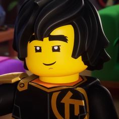 the lego movie character is wearing a black and gold outfit with his hair pulled back