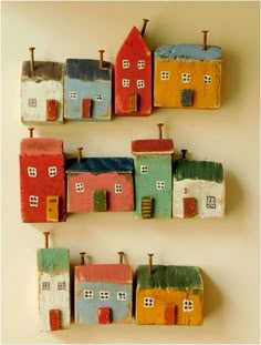 small wooden houses are arranged on top of each other in the shape of magnets