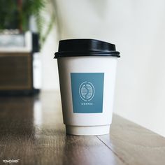 a coffee cup sitting on top of a wooden table